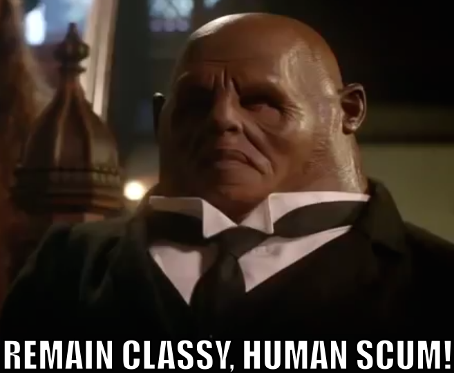 Strax, wearing a smart suit, says "REMAIN CLASSY, HUMAN SCUM!"